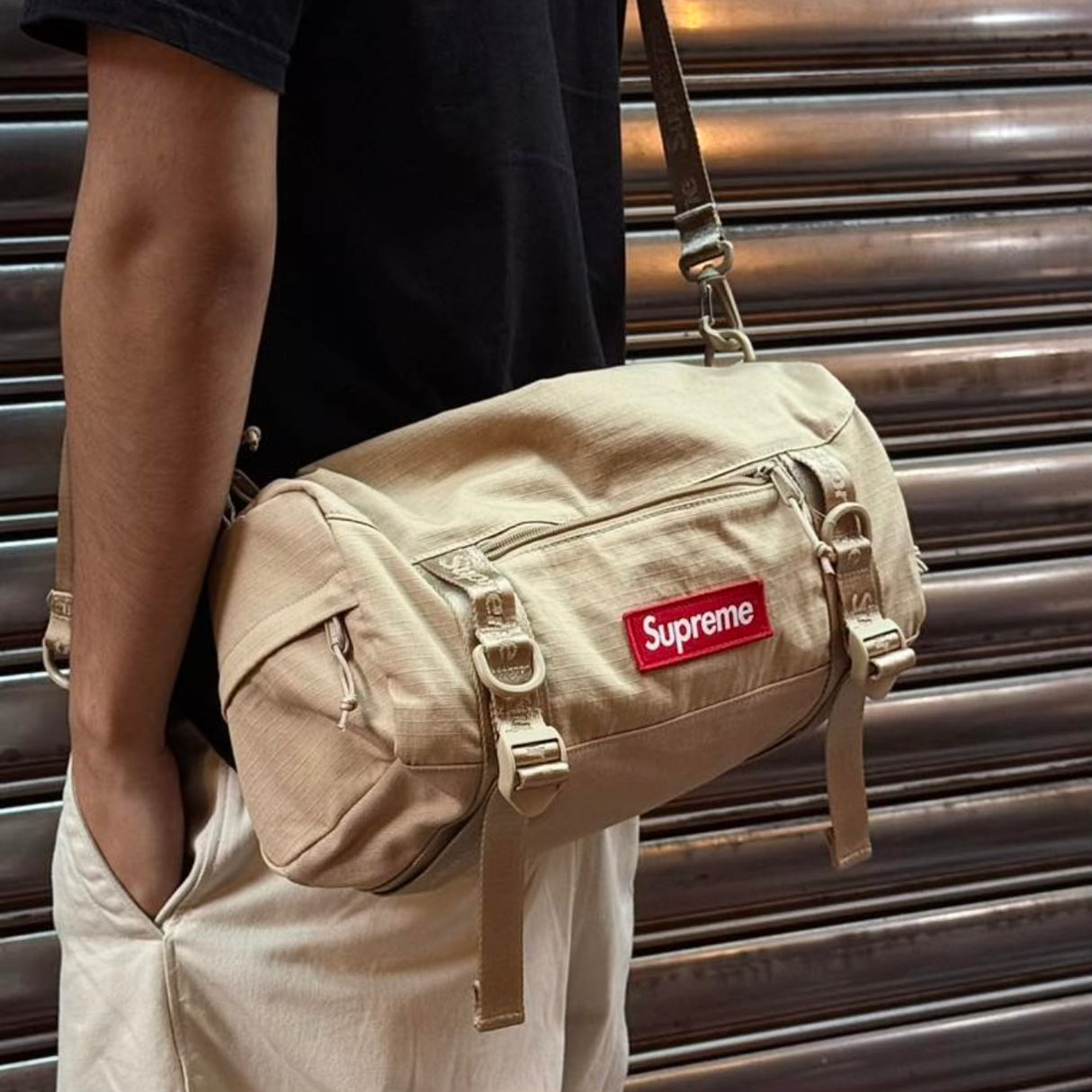 Tan Supreme box logo utility bag with adjustable strap, multiple compartments, and bold branding on durable fabric.