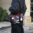 Supreme Box Logo Utility Bag in red camo with adjustable strap and zippered compartments, designed for versatile carrying.