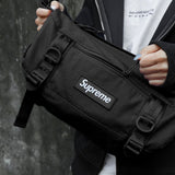 Supreme black box logo utility bag with adjustable strap, compact design, and multiple compartments for versatile storage.