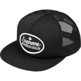 Black Supreme mesh trucker cap with adjustable snapback closure and embroidered logo, headwear by SUPREME.