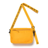 Yellow Human Made military sling bag with multiple pockets and adjustable strap, made of durable fabric.