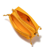 Yellow Human Made military sling bag with adjustable strap and multiple compartments, designed for casual and outdoor use.