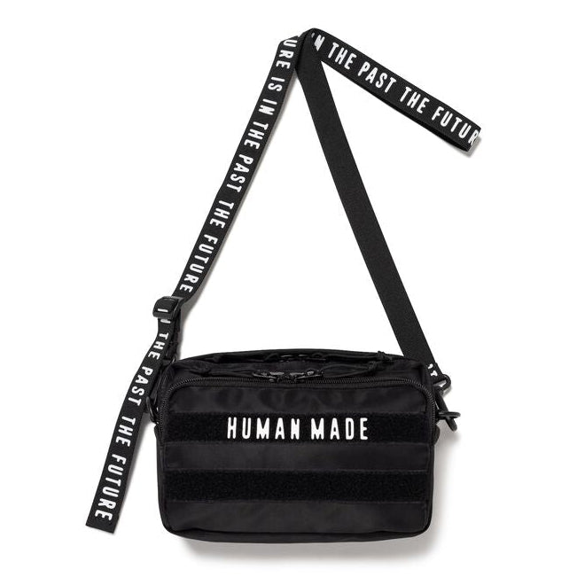 Black Human Made military sling bag with adjustable strap and multiple compartments, designed for casual or outdoor use.