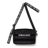 Black Human Made military sling bag with adjustable strap and multiple compartments, designed for casual or outdoor use.