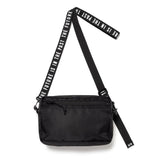 Black Human Made military sling bag with adjustable strap and multiple compartments, designed for casual and outdoor use.