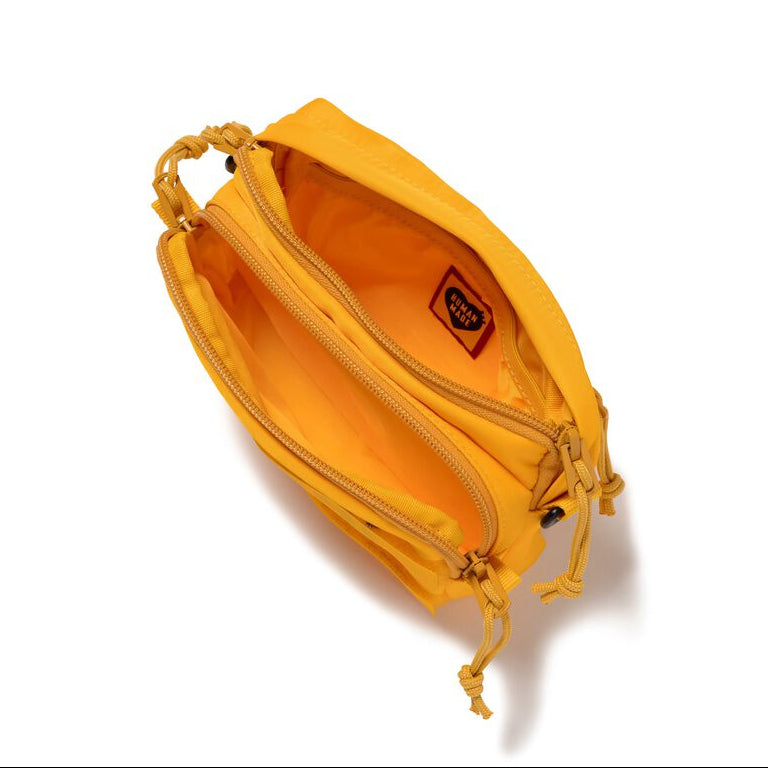 Yellow Human Made Military Mini Sling Bag with adjustable strap and compact design, perfect for casual carry.