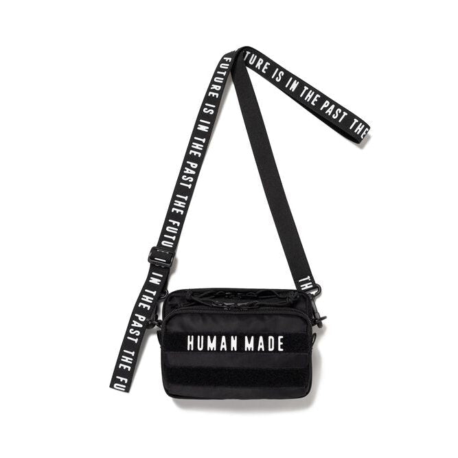 Black Human Made Military Mini Sling Bag with adjustable strap and sleek design, perfect for casual wear and outdoor activities.