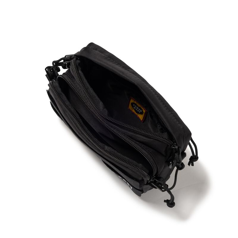 Black Human Made military mini sling bag with adjustable strap and compact design, perfect for casual and outdoor use.