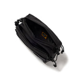 Black Human Made military mini sling bag with adjustable strap and compact design, perfect for casual and outdoor use.