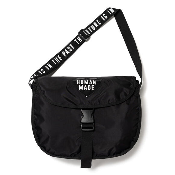 Black Human Made shoulder bag with adjustable strap and sleek design, featuring the brand's logo on the front.