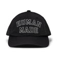 Black nylon 6-panel cap by HUMAN MADE with embroidered logo, showcasing casual headwear style and adjustable strap.