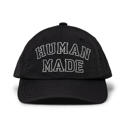 Black nylon 6-panel cap by HUMAN MADE with embroidered logo, showcasing casual headwear style and adjustable strap.