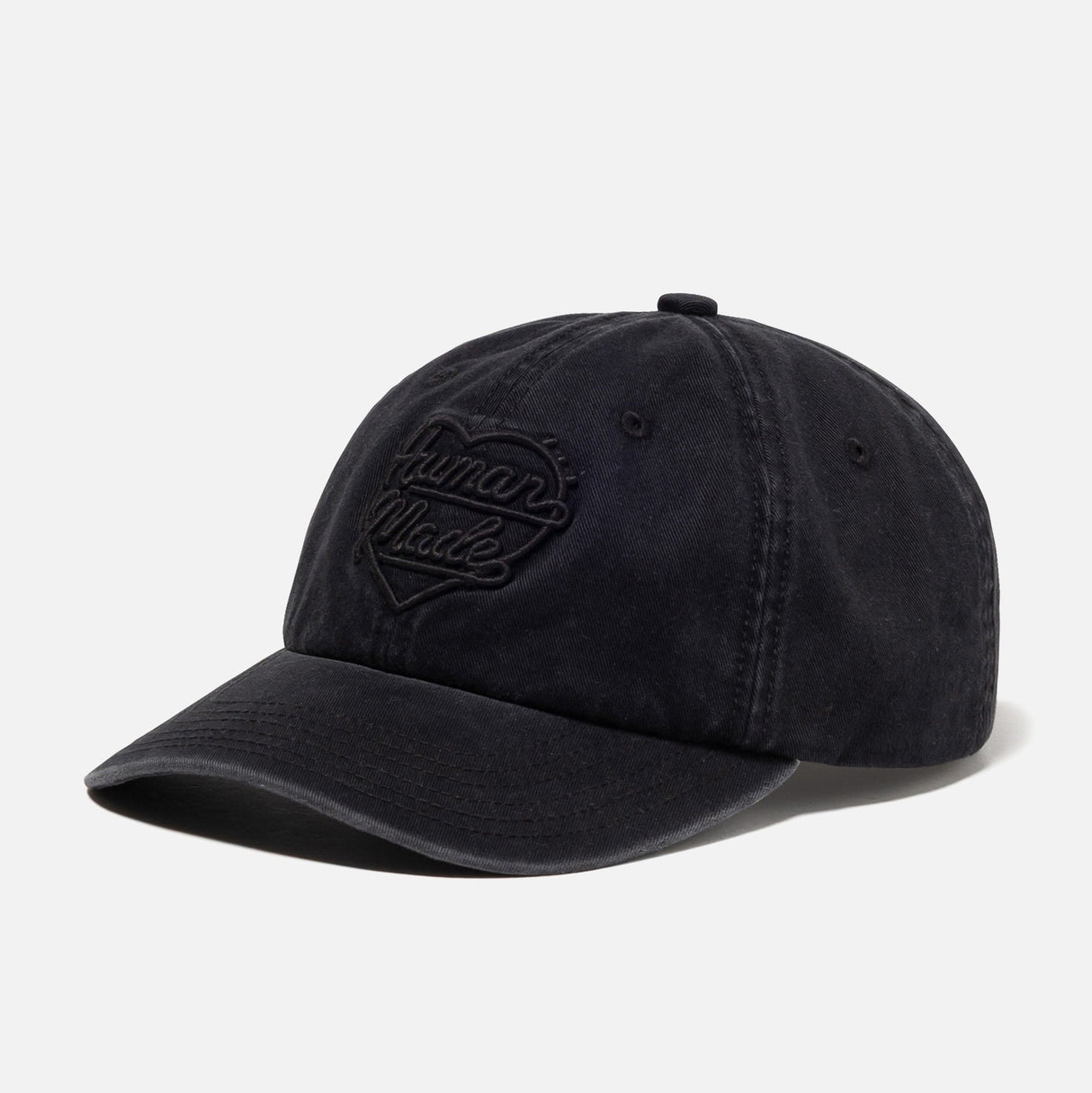 Black Human Made Heart Logo 6-panel cap, stylish headwear with embroidered heart logo on front, adjustable strap at back.