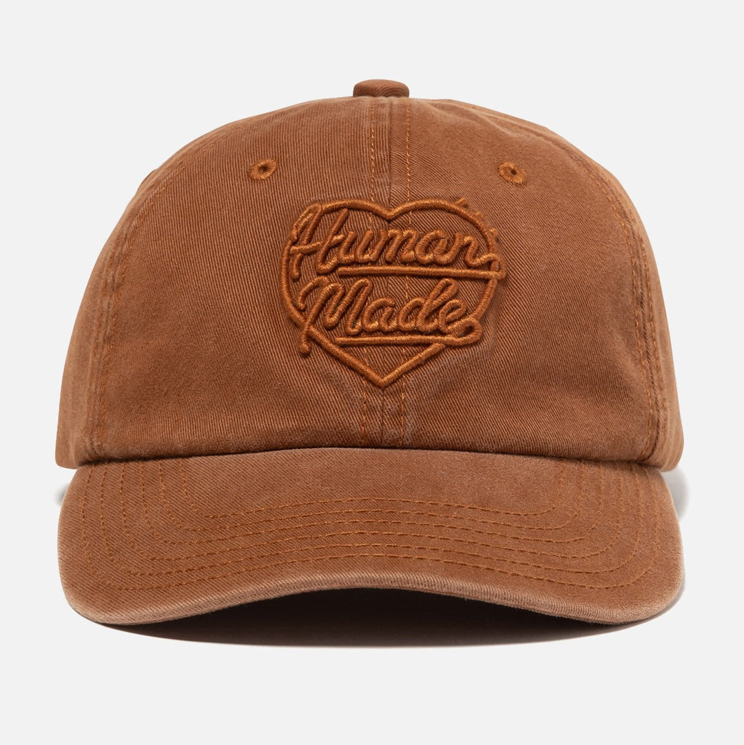 Human Made brown 6-panel cap featuring the heart logo, a stylish headwear accessory with adjustable strap and embroidered design.