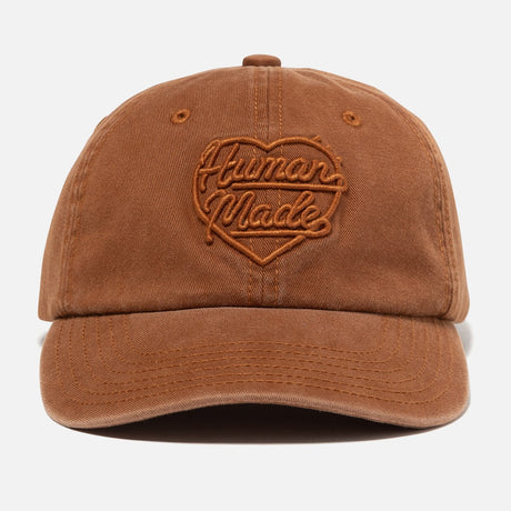 Human Made brown 6-panel cap featuring the heart logo, a stylish headwear accessory with adjustable strap and embroidered design.