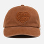 Human Made brown 6-panel cap featuring the heart logo, a stylish headwear accessory with adjustable strap and embroidered design.