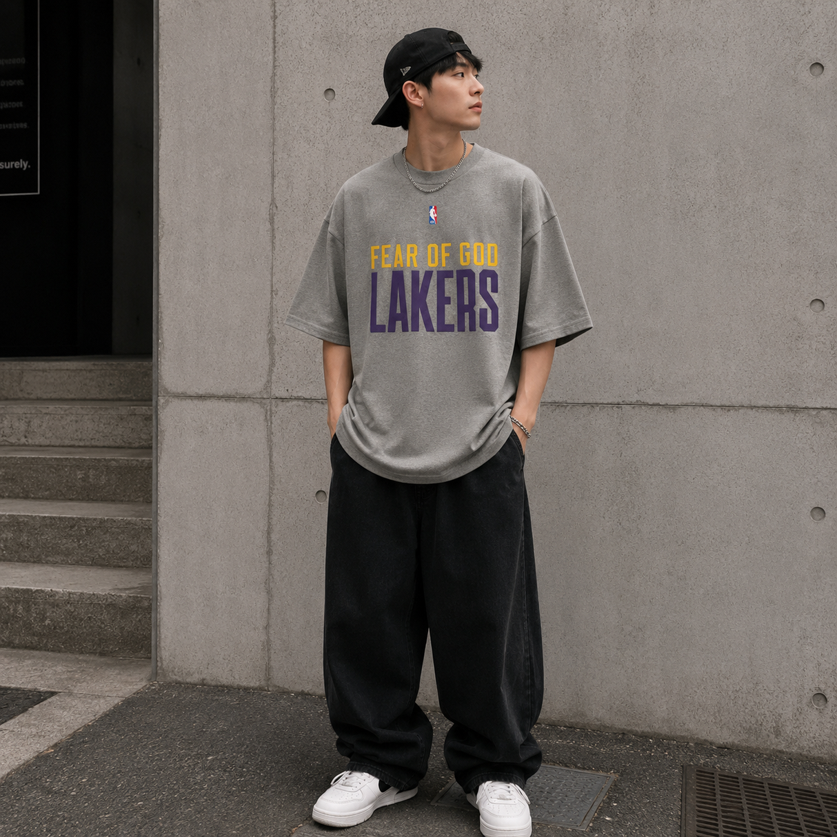 Fear of God Essentials x Lakers NBA 90s heavyweight tee in concrete, featuring bold Lakers logo and vintage-inspired design.