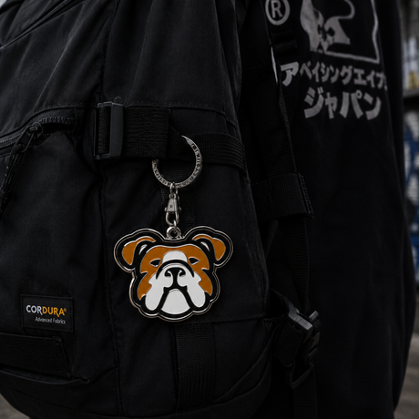 Human Made Bulldog Head keychain attached to a bag, featuring a detailed and stylish rubber design with branding accents.