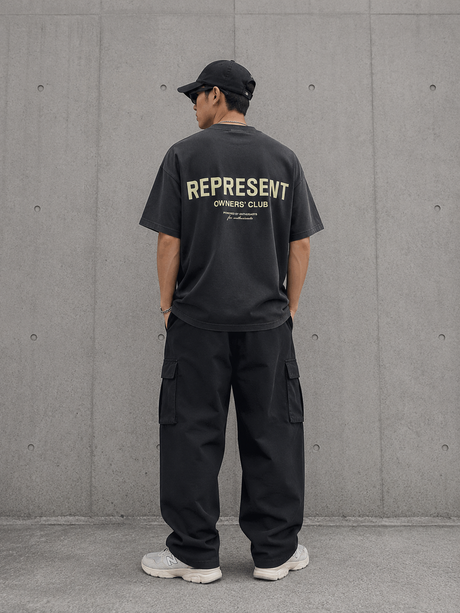Represent Owners Club Logo Tee in aged black, featuring the brand's distinctive logo on the front, casual fit, and soft fabric.