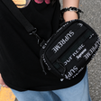 Supreme black reflective monogram logo mini shoulder bag with sleek design and adjustable strap for stylish carry.