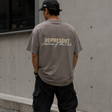 Olive green Represent Patron Of The Club Tee displayed flat, showing front view with logo design, casual streetwear style.
