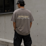 Olive green Represent Patron Of The Club Tee displayed flat, showing front view with logo design, casual streetwear style.
