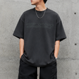 Fear of God Essentials reflective logo ponte 90s tee in upgraded fabric, showing the front view with logo detail.