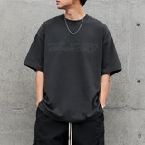 Fear of God Essentials reflective logo ponte 90s tee in upgraded fabric, showing the front view with logo detail.