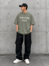 Fear of God Essentials 90's Tee Moss, casual moss green T-shirt from the FEAR OF GOD ESSENTIALS apparel collection.