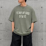 Fear of God Essentials 90's Tee Moss, casual men's t-shirt with retro style, soft fabric, and classic fit.