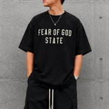 Fear of God Essentials 90's Tee in black, casual men's apparel featuring a classic fit and soft cotton fabric.