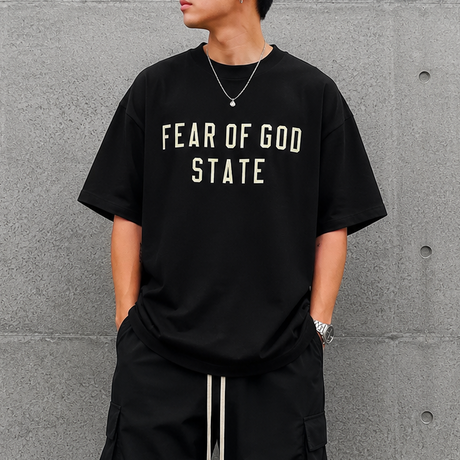 Fear of God Essentials 90's Tee in black, casual men's apparel featuring a classic fit and soft cotton fabric.