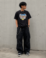 Black Human Made Tri-Color Heart Logo T-shirt showing the colorful heart design on the front.