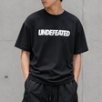 Black Undefeated Signature Logo Tee shirt featuring the brand's logo on the front, casual apparel for everyday wear.
