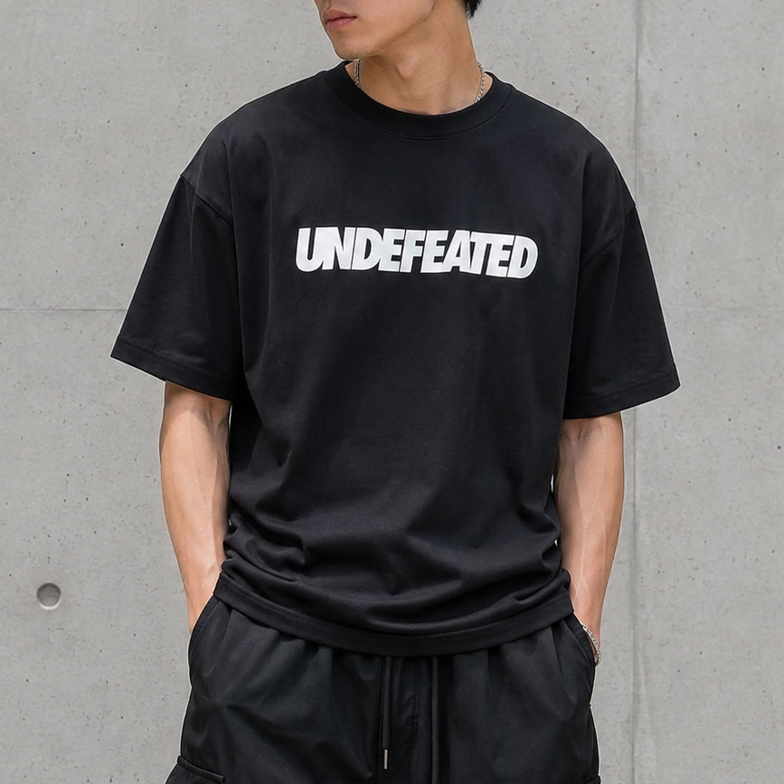 Black Undefeated Signature Logo Tee shirt featuring the brand's logo on the front, casual apparel for everyday wear.