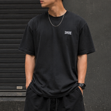 Supreme Warm Up Logo Tee in washed black, casual apparel with Supreme branding and a classic crew neck design.