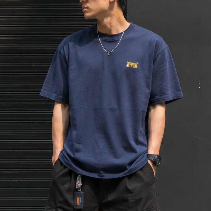 Supreme navy warm-up logo T-shirt, casual apparel with brand logo, displayed flat on a white background.
