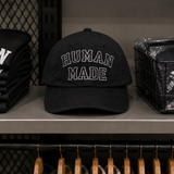 Black Human Made embroidered logo 6-panel cap, stylish headwear with detailed stitching and adjustable fit.