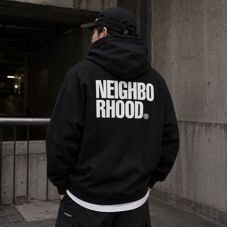 Black Neighborhood Classic Zip Hoodie displayed on a hanger, featuring the brand's logo on the chest and a front zipper.