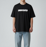 Black Undefeated Signature Logo Tee shirt, casual apparel featuring the iconic logo on the front, displayed flat.