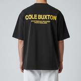 Cole Buxton Signature Tee in vintage black with yellow branding, featuring a classic fit and soft cotton fabric.