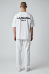 White Cole Buxton Signature Tee displayed on a hanger, showcasing the classic fit and soft cotton fabric.