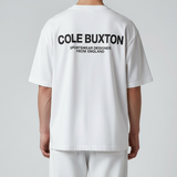 White Cole Buxton Signature Tee displayed on a hanger, showcasing a classic crew neck and minimalist design.