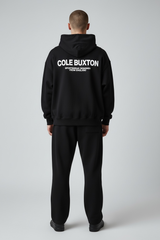 Black Cole Buxton Signature Hoodie with logo detail, featuring a relaxed fit and soft fabric, perfect for casual wear.
