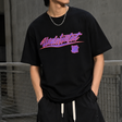 Black Undefeated Wrap Tee displayed flat with folded sleeves and front wrap detail, showcasing the casual, stylish design.