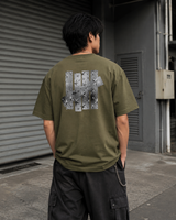 Undefeated Foil Photo Logo T-shirt in olive color, featuring a graphic logo design on the front, casual streetwear style.