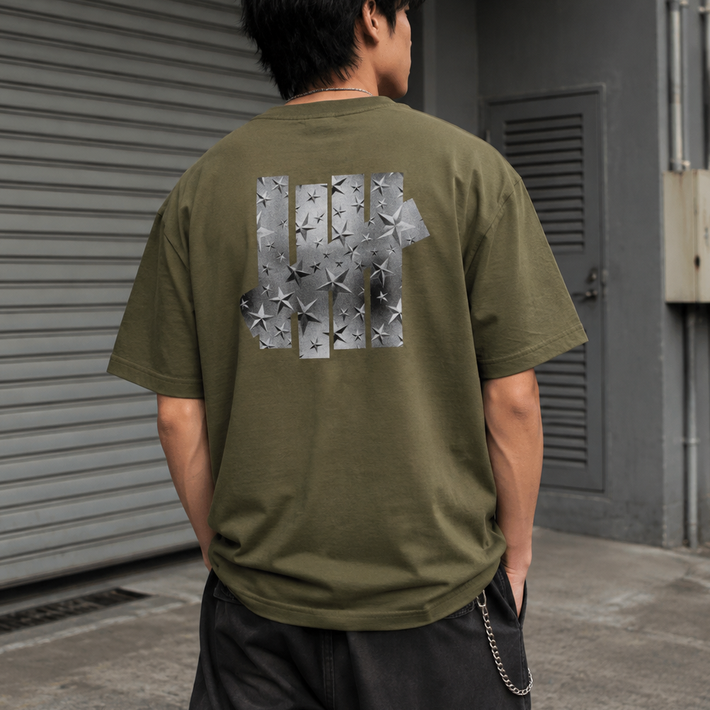 Olive green Undefeated foil photo logo T-shirt with graphic design on front, casual streetwear tee from UNDEFEATED.
