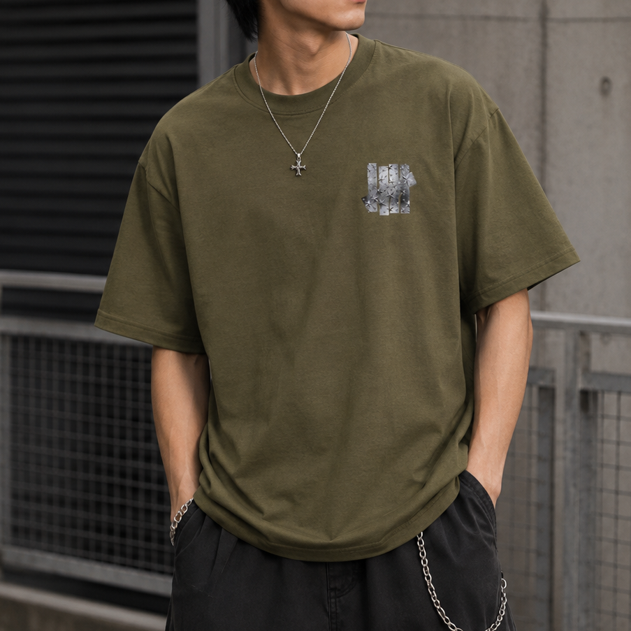 Undefeated foil photo logo olive green T-shirt with graphic design on front, casual streetwear style.