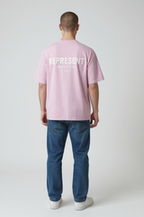 Lilac Represent Owners Club Logo Tee featuring the brand's signature design and branding on the front.