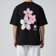 Takashi Murakami Sakura embroidered patch on black tee, showcasing vibrant floral design and detailed embroidery.